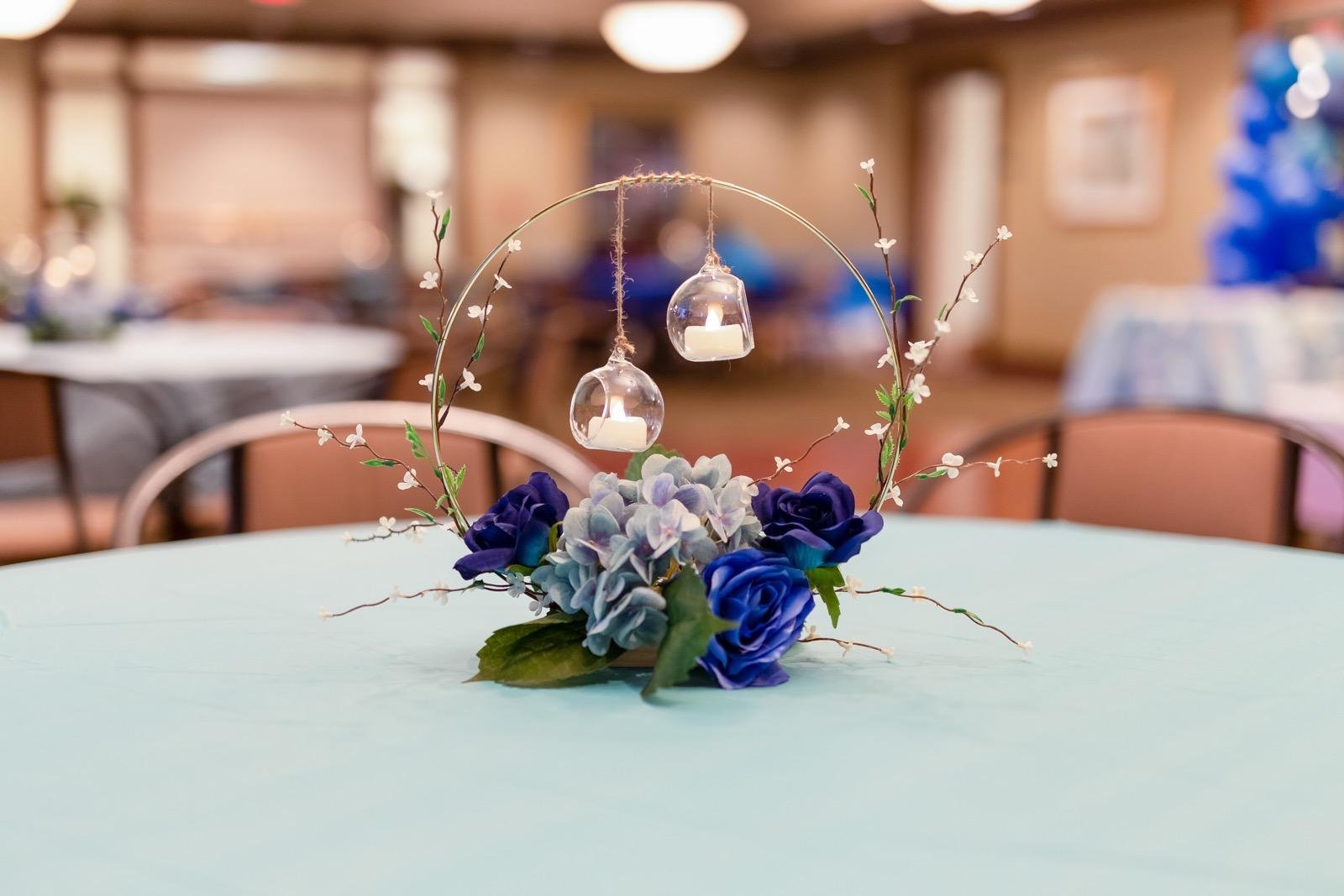 Blue floral hoop centerpiece with hanging tea lights