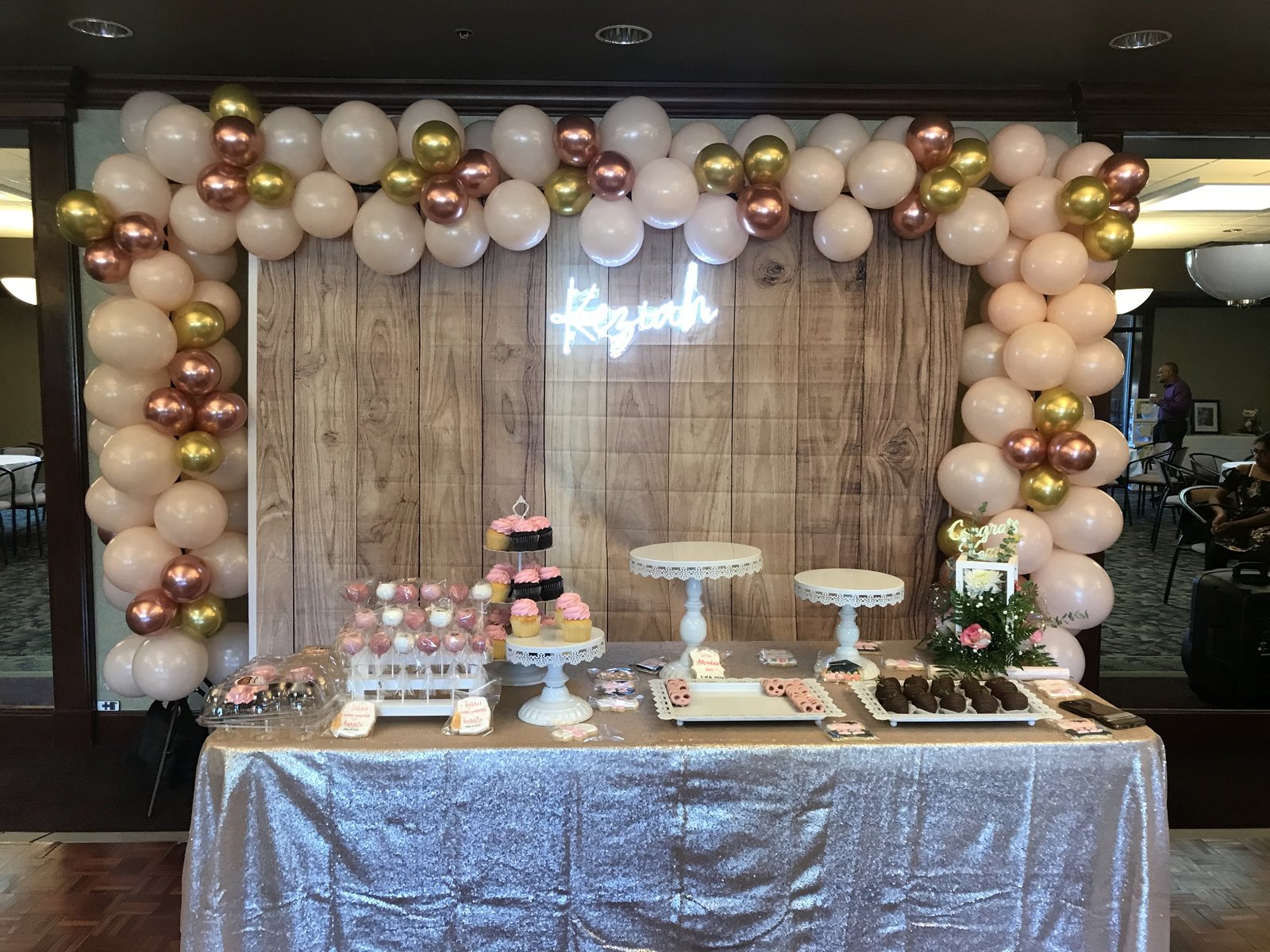 Elegant dessert bar with balloon arch