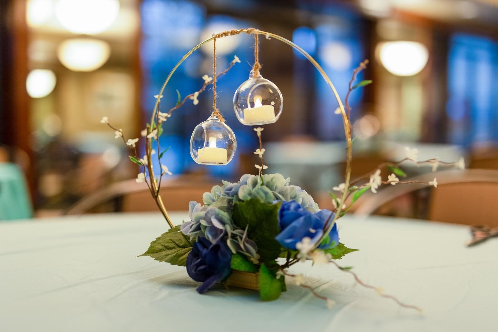 Blue floral hoop centerpiece with hanging candle globes