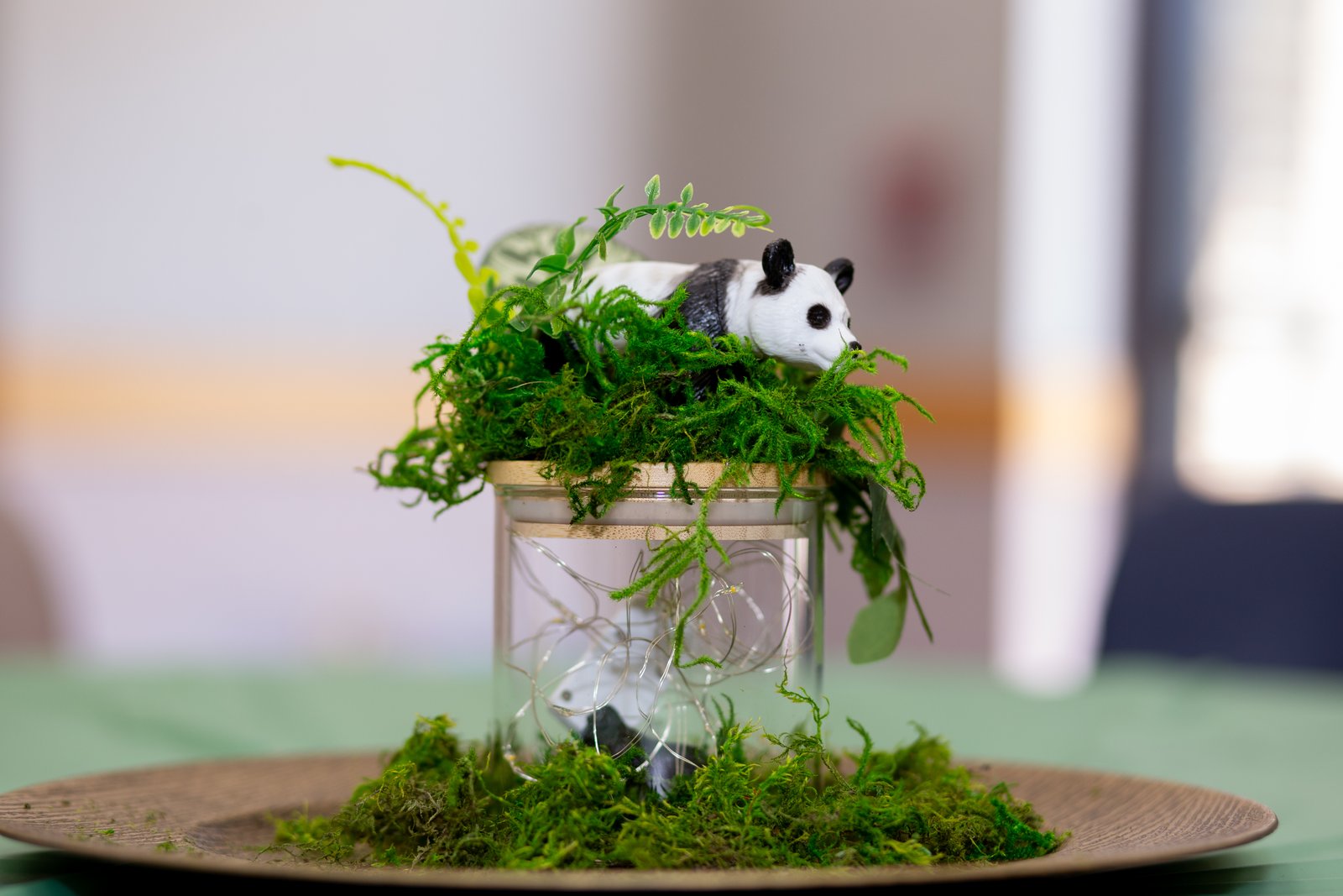 Panda safari centerpiece with moss on gold charger